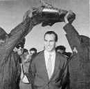 Hazar Imam passes under the Holy Qu'ran held aloft by Ismailis during His visit to Maymch, Iran on 1959-10-30